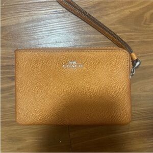 Coach leather Wristlet I’m shimmery orange limited edition.